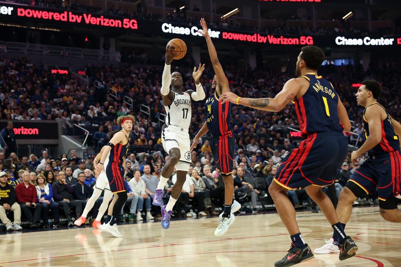 SAN FRANCISCO, CALIFORNIA - NOVEMBER 25: Dennis Schroder #17 of the Brooklyn Nets goes up for a shot on Moses Moody #4 of the Golden State Warriors in the first half at Chase Center on November 25, 2024 in San Francisco, California. NOTE TO USER: User expressly acknowledges and agrees that, by downloading and/or using this photograph, user is consenting to the terms and conditions of the Getty Images License Agreement.   (Photo by Ezra Shaw/Getty Images)