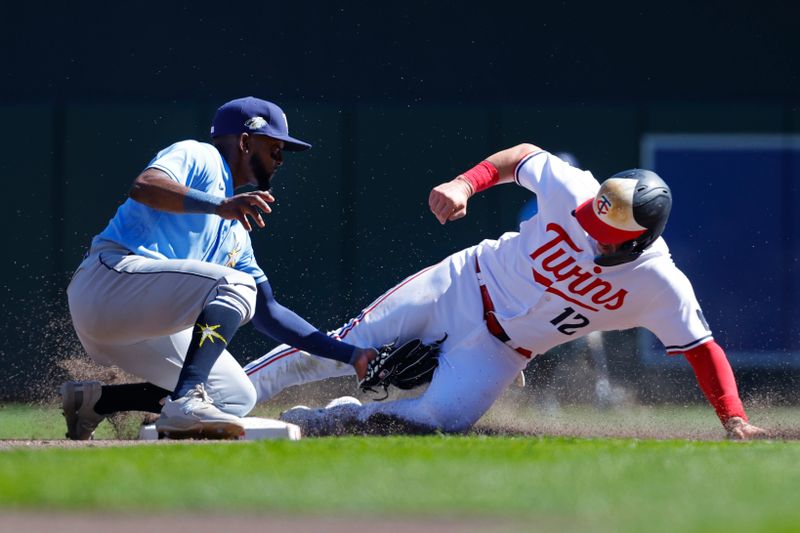 Sep 13, 2023; Minneapolis, Minnesota, USA; Tampa Bay Rays shortstop Vidal Brujan (7) tags out Minnesota Twins second baseman Kyle Farmer (12) on an attempted steal of second base in the seventh inning at Target Field. Mandatory Credit: Bruce Kluckhohn-USA TODAY Sports