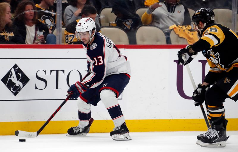 Mar 5, 2024; Pittsburgh, Pennsylvania, USA; Columbus Blue Jackets left wing Johnny Gaudreau (13) skates with the puck as Pittsburgh Penguins defenseman Kris Letang (58) chases during the second period at PPG Paints Arena. Mandatory Credit: Charles LeClaire-USA TODAY Sports