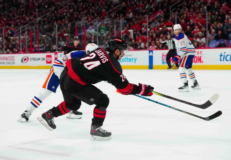 Nov 22, 2023; Raleigh, North Carolina, USA; Carolina Hurricanes center Seth Jarvis (24) scores a goal against the Edmonton Oilers during the first period at PNC Arena. Mandatory Credit: James Guillory-USA TODAY Sports