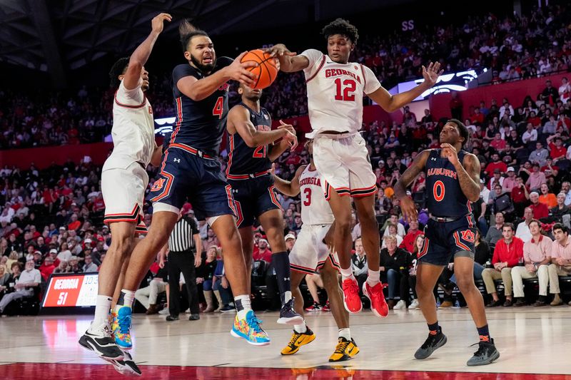 Jan 4, 2023; Athens, Georgia, USA; Auburn Tigers forward Johni Broome (4) and Georgia Bulldogs forward Matthew-Alexander Moncrieffe (12) fight for a rebound during the second half at Stegeman Coliseum. Mandatory Credit: Dale Zanine-USA TODAY Sports