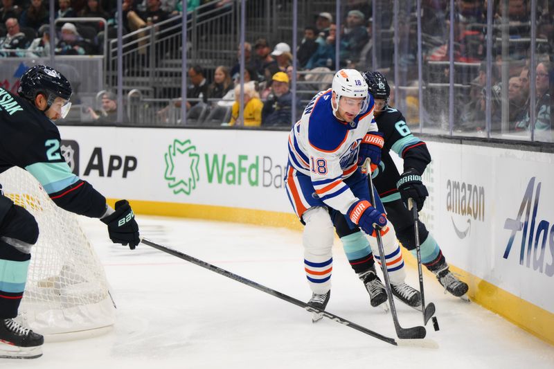 Oct 2, 2024; Seattle, Washington, USA; Edmonton Oilers left wing Zach Hyman (18) protects the puck from Seattle Kraken defenseman Brandon Montour (62) during the second period at Climate Pledge Arena. Mandatory Credit: Steven Bisig-Imagn Images