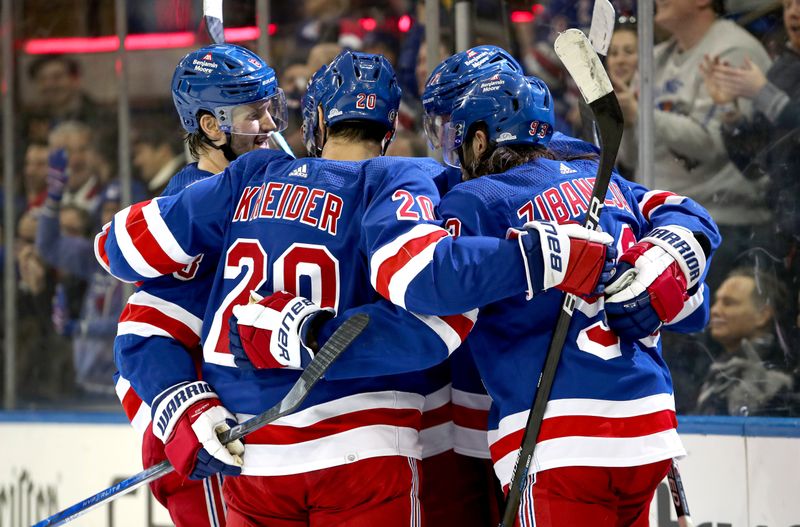 Nov 25, 2023; New York, New York, USA; New York Rangers defenseman K'Andre Miller (79) celebrates his goal with center Mika Zibanejad (93), defenseman Jacob Trouba (8) and left wing Chris Kreider (20) during the second period against the Boston Bruins at Madison Square Garden. Mandatory Credit: Danny Wild-USA TODAY Sports