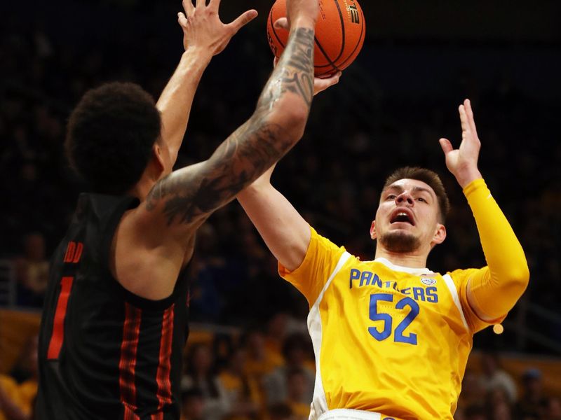 Feb 15, 2025; Pittsburgh, Pennsylvania, USA; Pittsburgh Panthers guard Amsal Delalic (52) shoots against Miami (Fl) Hurricanes center Lynn Kidd (1) during the second half at the Petersen Events Center. Mandatory Credit: Charles LeClaire-Imagn Images