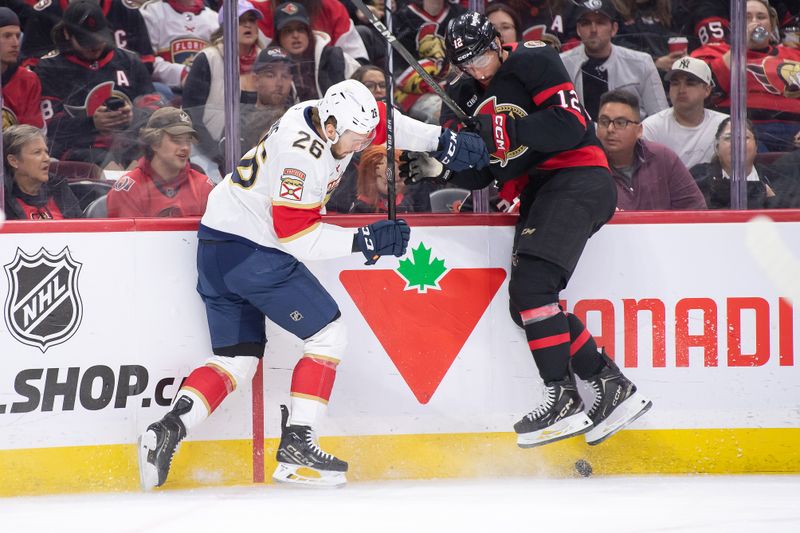Oct 10, 2024; Ottawa, Ontario, CAN; Florida Panthers defenseman Uvis Balinskis (26) and Ottawa Senators center Shane Pinto (12) chase the puck in the first period at the Canadian Tire Centre. Mandatory Credit: Marc DesRosiers-Imagn Images