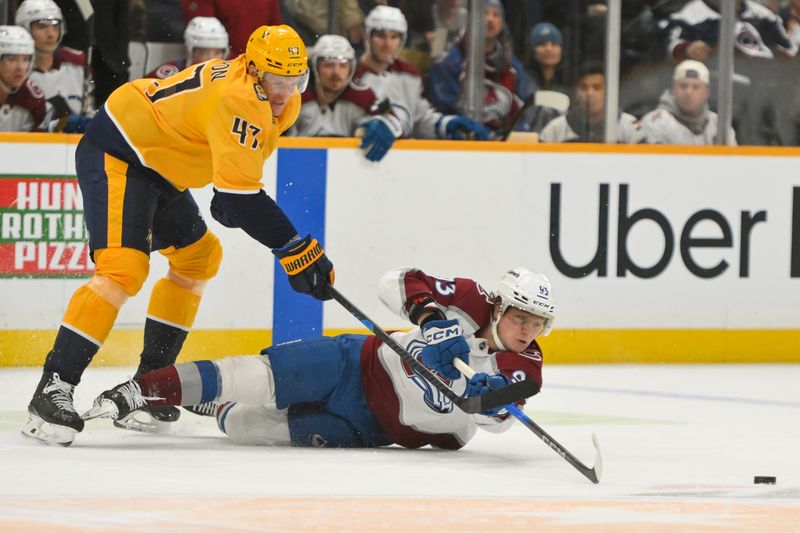 Dec 9, 2025; Nashville, Tennessee, USA;  Colorado Avalanche left wing Victor Olofsson (95) and Nashville Predators right wing Michael McCarron (47) battle for the puck during the first period at Bridgestone Arena. Mandatory Credit: Steve Roberts-Imagn Images