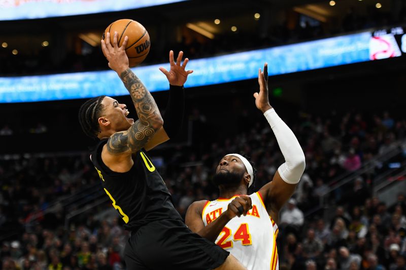 SALT LAKE CITY, UTAH - MARCH 15: Keyonte George #3 of the Utah Jazz shoots over Bruno Fernando #24 of the Atlanta Hawks during the second half of a game at Delta Center on March 15, 2024 in Salt Lake City, Utah.  NOTE TO USER: User expressly acknowledges and agrees that, by downloading and or using this photograph, User is consenting to the terms and conditions of the Getty Images License Agreement.  (Photo by Alex Goodlett/Getty Images)