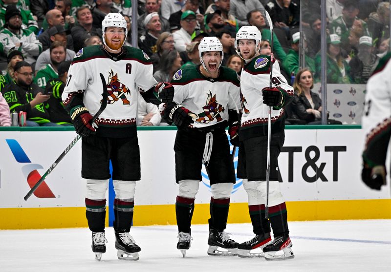 Nov 14, 2023; Dallas, Texas, USA; Arizona Coyotes left wing Lawson Crouse (67) and left wing Jason Zucker (16) and defenseman J.J. Moser (90) celebrates a goal scored by Zucker against the Dallas Stars during the third period at the American Airlines Center. Mandatory Credit: Jerome Miron-USA TODAY Sports