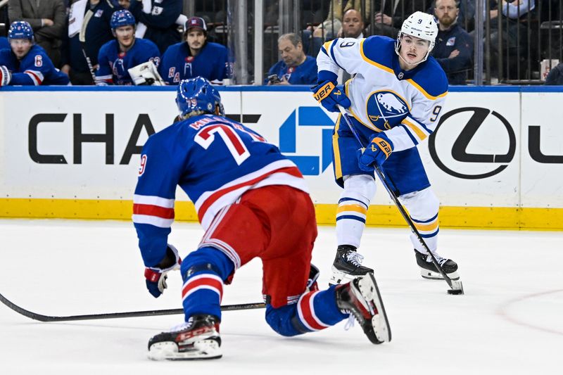 Nov 7, 2024; New York, New York, USA;  Buffalo Sabres left wing Zach Benson (9) passes against New York Rangers defenseman K'Andre Miller (79) during the third period at Madison Square Garden. Mandatory Credit: Dennis Schneidler-Imagn Images