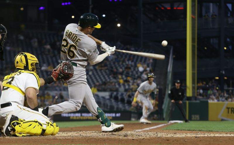 Jun 6, 2023; Pittsburgh, Pennsylvania, USA; Oakland Athletics third baseman Jonah Bride (26) hits an RBI single against the Pittsburgh Pirates during the sixth inning at PNC Park. Mandatory Credit: Charles LeClaire-USA TODAY Sports