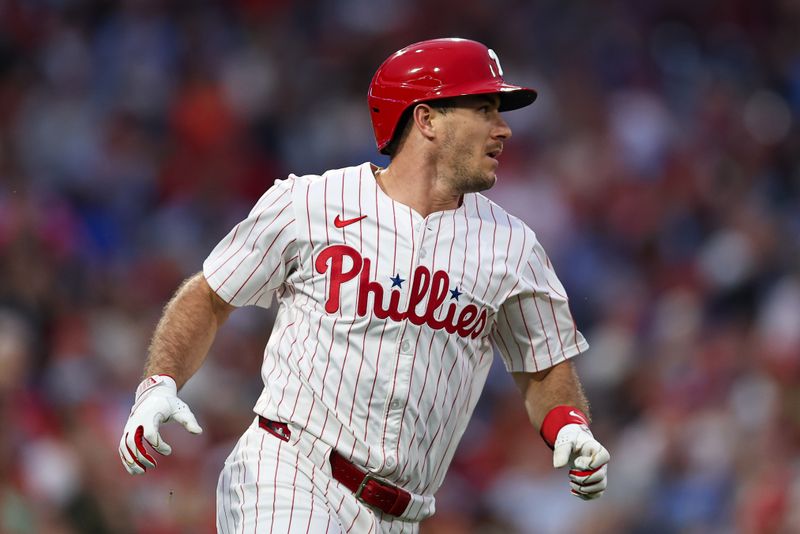 Sep 10, 2025; Philadelphia, Pennsylvania, USA; Philadelphia Phillies catcher J.T. Realmuto (10) hits an RBI single against the New York Mets during the first inning at Citizens Bank Park. Mandatory Credit: Bill Streicher-Imagn Images