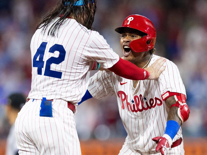 Apr 15, 2024; Philadelphia, Pennsylvania, USA; Philadelphia Phillies outfielder Cristian Pache (R) celebrates with outfielder Brandon Marsh (42) after hitting a walk off RBI single during the tenth inning against the Colorado Rockies at Citizens Bank Park. Mandatory Credit: Bill Streicher-USA TODAY Sports