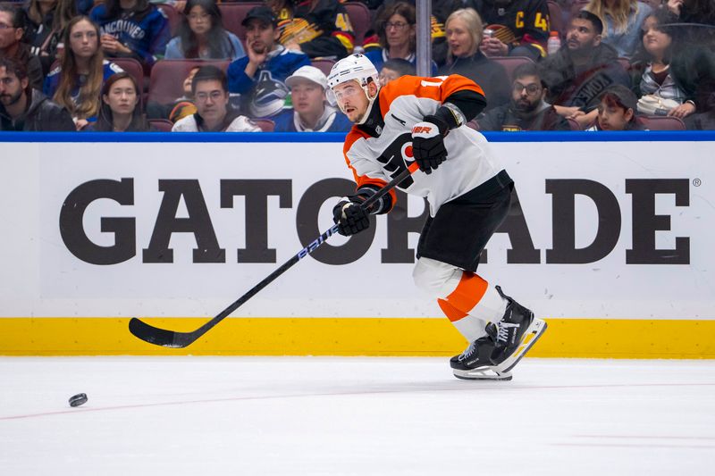 Oct 11, 2024; Vancouver, British Columbia, CAN; Philadelphia Flyers forward Travis Konecny (11) passes the puck against the Vancouver Canucks during the third period at Rogers Arena. Mandatory Credit: Bob Frid-Imagn Images