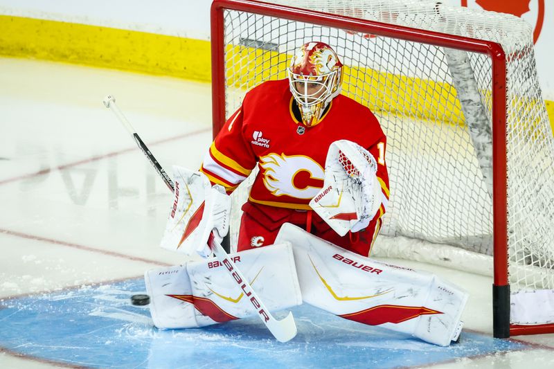 Sep 21, 2025; Calgary, Alberta, CAN; Calgary Flames goaltender Devin Cooley (1) guards his net during the warmup period against the Edmonton Oilers at Scotiabank Saddledome. Mandatory Credit: Sergei Belski-Imagn Images