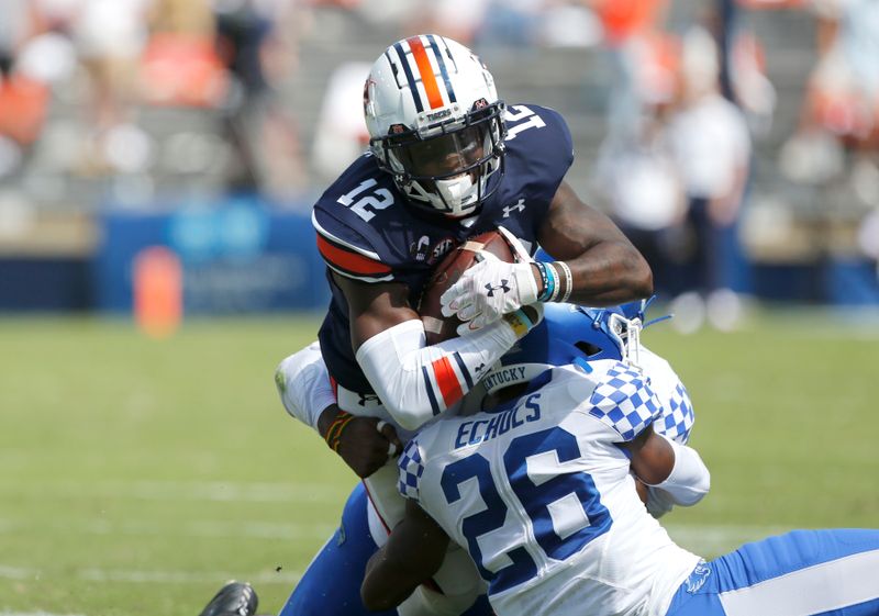 Sep 26, 2020; Auburn, Alabama, USA;  Auburn Tigers receiver Eli Stove (12) is tackled by Kentucky Wildcats defensive back Brandin Echols (26) during the first quarter at Jordan-Hare Stadium. Mandatory Credit: John Reed-USA TODAY Sports