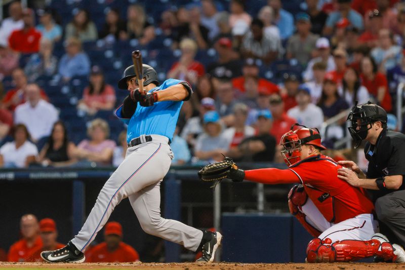 Mar 10, 2023; West Palm Beach, Florida, USA; Miami Marlins catcher Nick Fortes (4) hits a single during the third inning against the Washington Nationals at The Ballpark of the Palm Beaches. Mandatory Credit: Sam Navarro-USA TODAY Sports