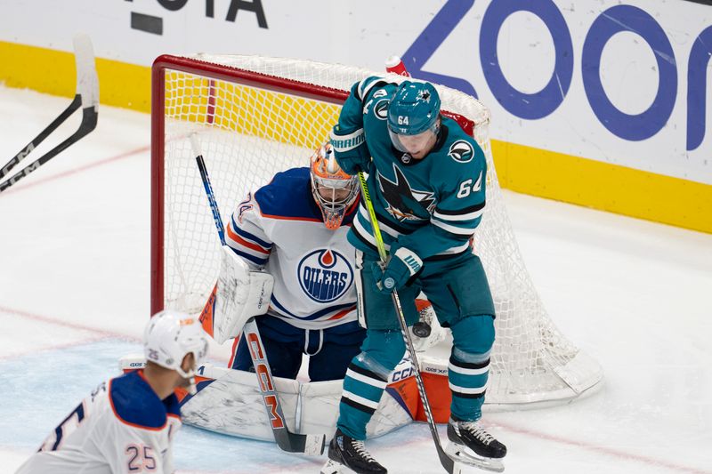 Dec 28, 2023; San Jose, California, USA; Edmonton Oilers goaltender Stuart Skinner (74) makes a save agains the deflection from San Jose Sharks center Mikael Granlund (64) during the third period at SAP Center at San Jose. Mandatory Credit: Neville E. Guard-USA TODAY Sports