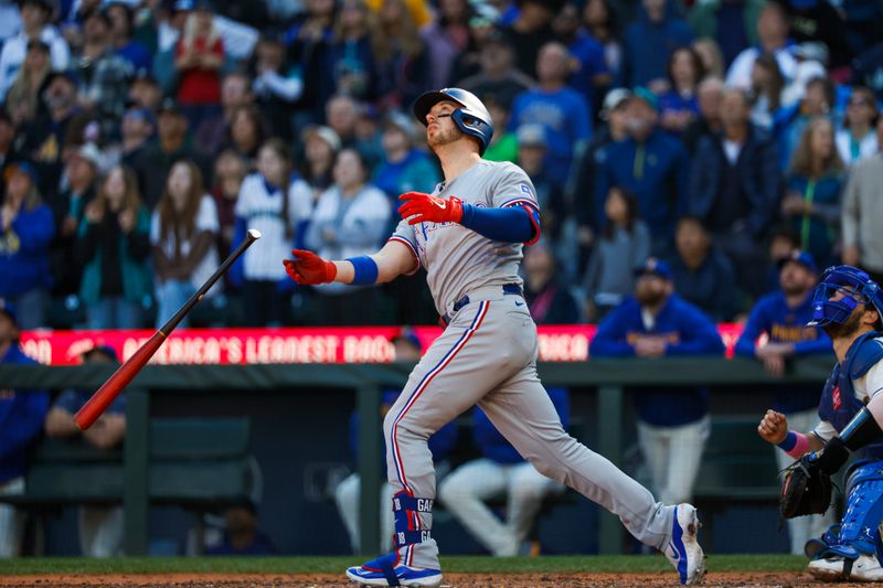 Oct 1, 2023; Seattle, Washington, USA; Texas Rangers designated hitter Mitch Garver (18) reacts after hitting a fly out to end a 1-0 loss against the Seattle Mariners at T-Mobile Park. Mandatory Credit: Joe Nicholson-USA TODAY Sports