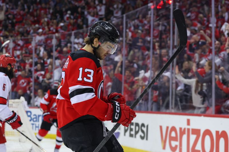 Apr 27, 2025; Newark, New Jersey, USA; New Jersey Devils center Nico Hischier (13) celebrates his goal against the Carolina Hurricanes during the second period in game four of the first round of the 2025 Stanley Cup Playoffs at Prudential Center. Mandatory Credit: Ed Mulholland-Imagn Images