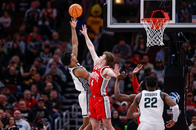 Mar 10, 2023; Chicago, IL, USA; Michigan State Spartans guard Jaden Akins (3) goes to the basket against Ohio State Buckeyes guard Sean McNeil (4) during the first half at United Center. Mandatory Credit: Kamil Krzaczynski-USA TODAY Sports