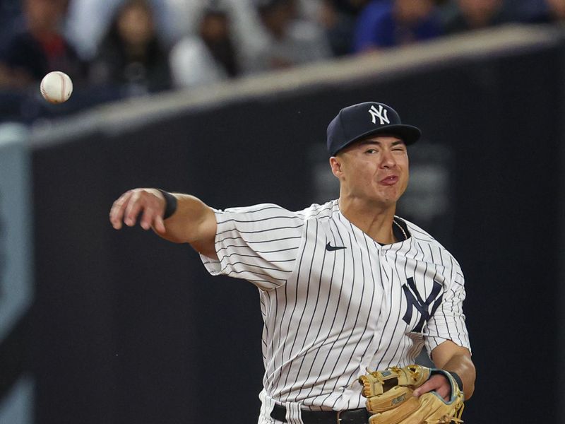 Aug 23, 2023; Bronx, New York, USA; New York Yankees shortstop Anthony Volpe (11) throws the ball to first base for an out during the fourth inning against the Washington Nationals during the second inning at Yankee Stadium. Mandatory Credit: Vincent Carchietta-USA TODAY Sports