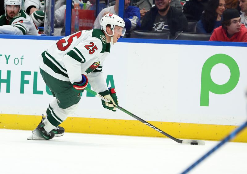 Jan 18, 2024; Tampa, Florida, USA; Minnesota Wild defenseman Jonas Brodin (25) skates with the puck against the Tampa Bay Lightning during the second period at Amalie Arena. Mandatory Credit: Kim Klement Neitzel-USA TODAY Sports