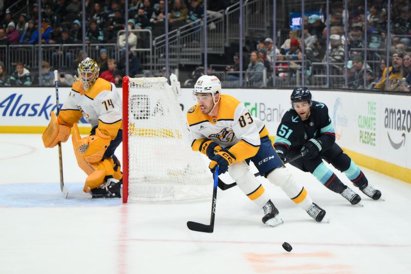 Jan 1, 2026; Seattle, Washington, USA; Nashville Predators defenseman Adam Wilsby (83) plays the puck while defended by Seattle Kraken center Shane Wright (51) during the second period at Climate Pledge Arena. Mandatory Credit: Steven Bisig-Imagn Images