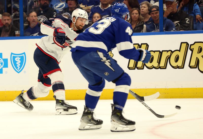 Apr 9, 2024; Tampa, Florida, USA; Columbus Blue Jackets center Sean Kuraly (7) shoots as Tampa Bay Lightning defenseman Darren Raddysh (43) defends during the second period at Amalie Arena. Mandatory Credit: Kim Klement Neitzel-USA TODAY Sports