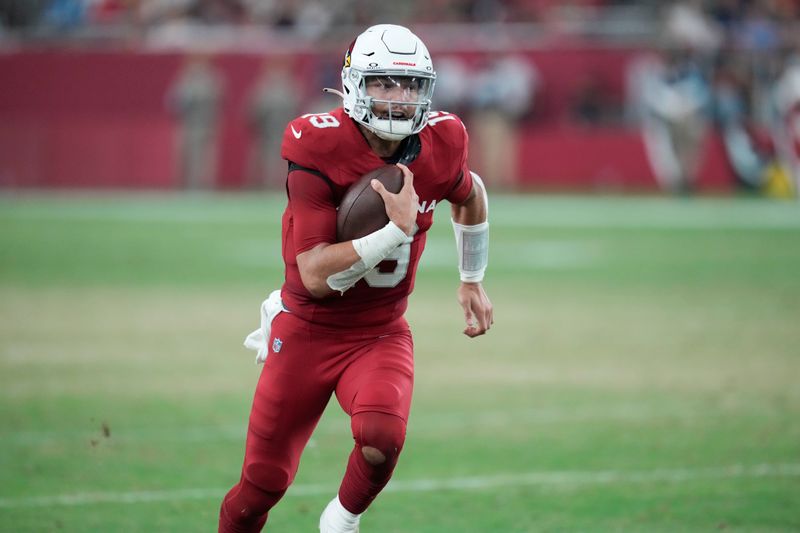 Arizona Cardinals quarterback Desmond Ridder (19) carries in the first half of a preseason NFL football game against the New Orleans Saints, Saturday, Aug. 10, 2024, in Glendale, Ariz. (AP Photo/Ross D. Franklin)