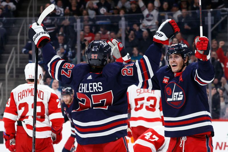 Dec 20, 2023; Winnipeg, Manitoba, CAN; Winnipeg Jets left wing Nikolaj Ehlers (27) celebrates his second period goal with Winnipeg Jets center Mark Scheifele (55) against the Detroit Red Wings at Canada Life Centre. Mandatory Credit: James Carey Lauder-USA TODAY Sports