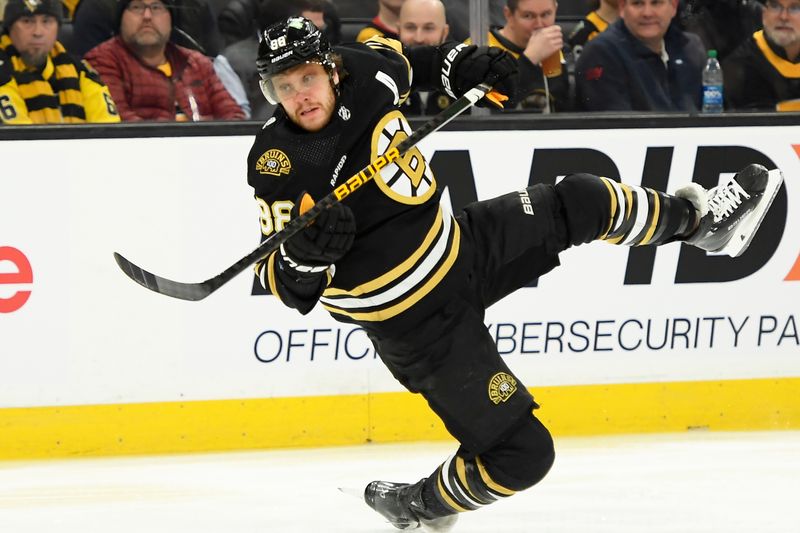 Jan 4, 2024; Boston, Massachusetts, USA; Boston Bruins right wing David Pastrnak (88) loses his balance after shooting the puck during the first period against the Pittsburgh Penguins at TD Garden. Mandatory Credit: Bob DeChiara-USA TODAY Sports