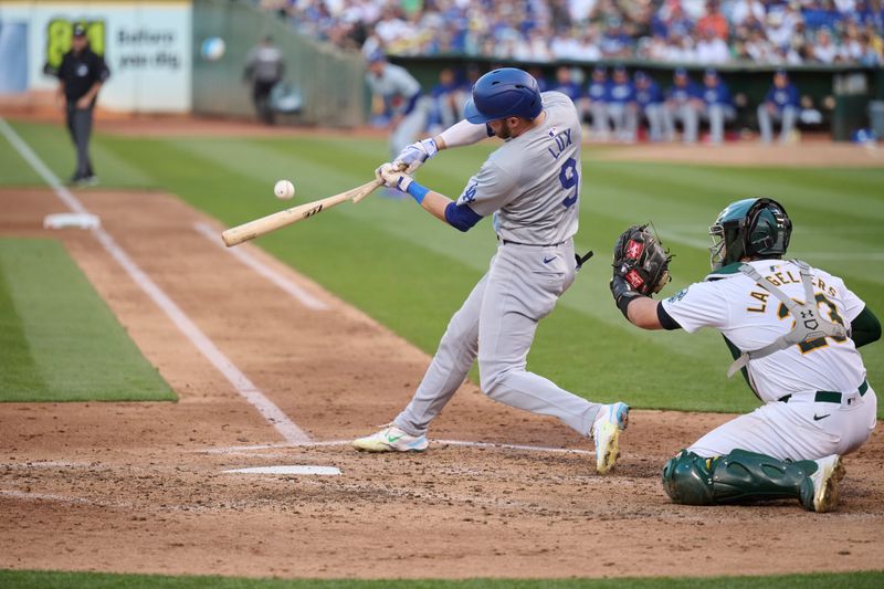 Aug 3, 2024; Oakland, California, USA; Los Angeles Dodgers infielder Gavin Lux (9) breaks his bat hitting a fly ball against the Oakland Athletics during the fifth inning at Oakland-Alameda County Coliseum. Mandatory Credit: Robert Edwards-USA TODAY Sports