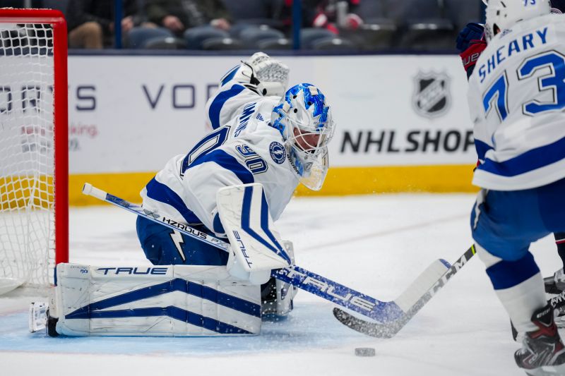 Nov 2, 2023; Columbus, Ohio, USA;  Tampa Bay Lightning goaltender Matt Tomkins (90) attempts a save in net against the Columbus Blue Jackets in the first period at Nationwide Arena. Mandatory Credit: Aaron Doster-USA TODAY Sports