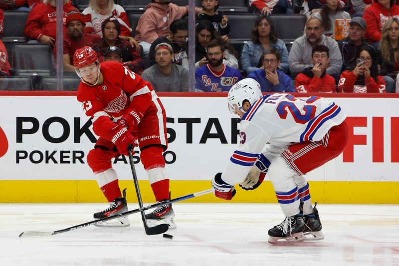 Oct 17, 2024; Detroit, Michigan, USA;  Detroit Red Wings left wing Lucas Raymond (23) skates with the puck defended by New York Rangers defenseman Adam Fox (23) in the second period at Little Caesars Arena. Mandatory Credit: Rick Osentoski-Imagn Images