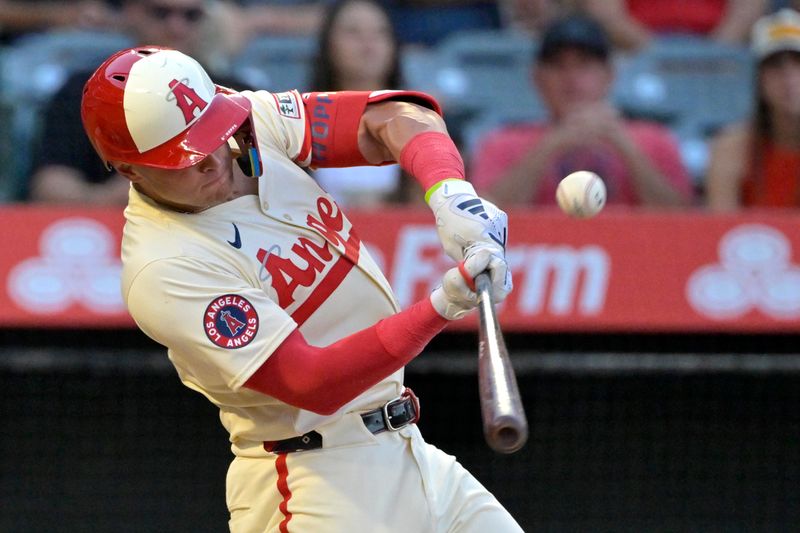 Jun 24, 2024; Anaheim, California, USA;  Los Angeles Angels catcher Logan O'Hoppe (14) hits a sacrifice fly to drive in a run in the third inning against the Oakland Athletics at Angel Stadium. Mandatory Credit: Jayne Kamin-Oncea-USA TODAY Sports