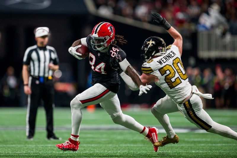 Atlanta Falcons running back Cordarrelle Patterson (84) runs the ball against New Orleans Saints linebacker Pete Werner (20) during the first half of an NFL football game, Sunday, Nov. 26, 2023, in Atlanta. The Atlanta Falcons won 24-15. (AP Photo/Danny Karnik)