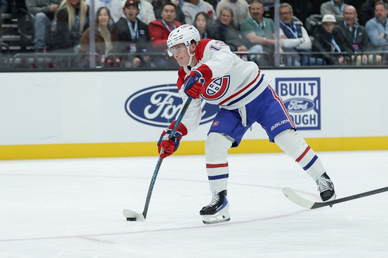 Nov 26, 2025; Salt Lake City, Utah, USA; Montreal Canadiens right wing Cole Caufield (13) shoots the puck against the Utah Mammoth during the second period at Delta Center. Mandatory Credit: Chris Nicoll-Imagn Images