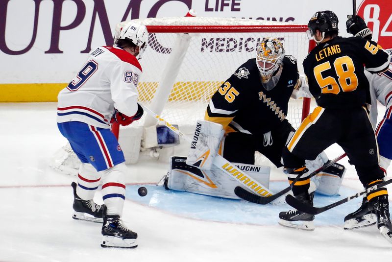 Feb 22, 2024; Pittsburgh, Pennsylvania, USA; Pittsburgh Penguins goaltender Tristan Jarry (35) makes a save against Montreal Canadiens right wing Joshua Roy (89) during the third period at PPG Paints Arena. The Penguins won 4-1.Mandatory Credit: Charles LeClaire-USA TODAY Sports