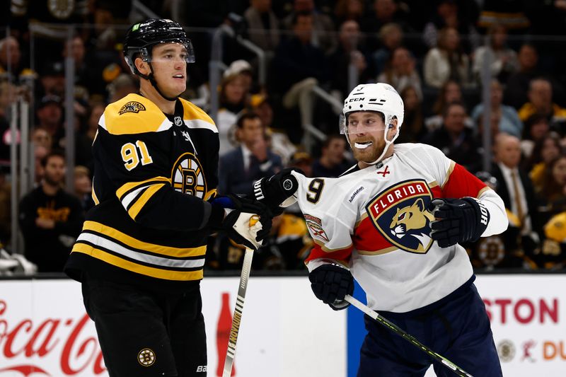 Oct 14, 2024; Boston, Massachusetts, USA; Boston Bruins defenseman Nikita Zadorov (91) grabs onto the jersey of Florida Panthers center Sam Bennett (9) during the first period at TD Garden. Mandatory Credit: Winslow Townson-Imagn Images