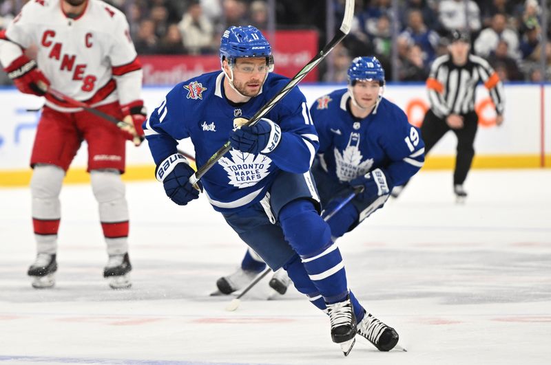 Dec 30, 2023; Toronto, Ontario, CAN; Toronto Maple Leafs forward Max Domi (11) pursues the play against the Carolina Hurricanes in the first period at Scotiabank Arena. Mandatory Credit: Dan Hamilton-USA TODAY Sports