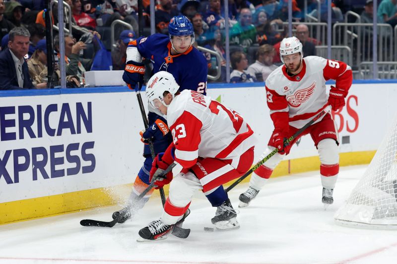 Oct 22, 2024; Elmont, New York, USA; New York Islanders defenseman Alexander Romanov (28) fights for the puck against Detroit Red Wings left wing Lucas Raymond (23) and right wing Alex DeBrincat (93) during the third period at UBS Arena. Mandatory Credit: Brad Penner-Imagn Images