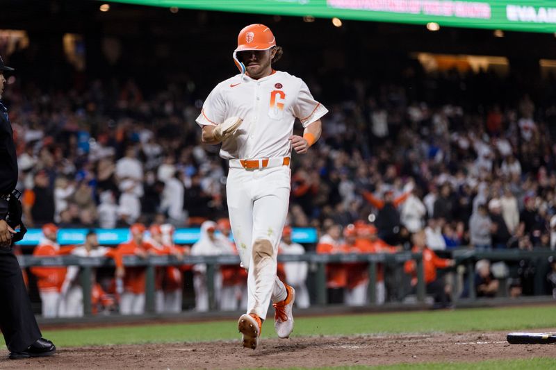 Jun 25, 2024; San Francisco, California, USA; San Francisco Giants shortstop Brett Wisely (0) scores against the Chicago Cubs on a sacrifice fly by designated hitter Jorge Soler (not pictured) during the eighth inning at Oracle Park. Mandatory Credit: John Hefti-USA TODAY Sports