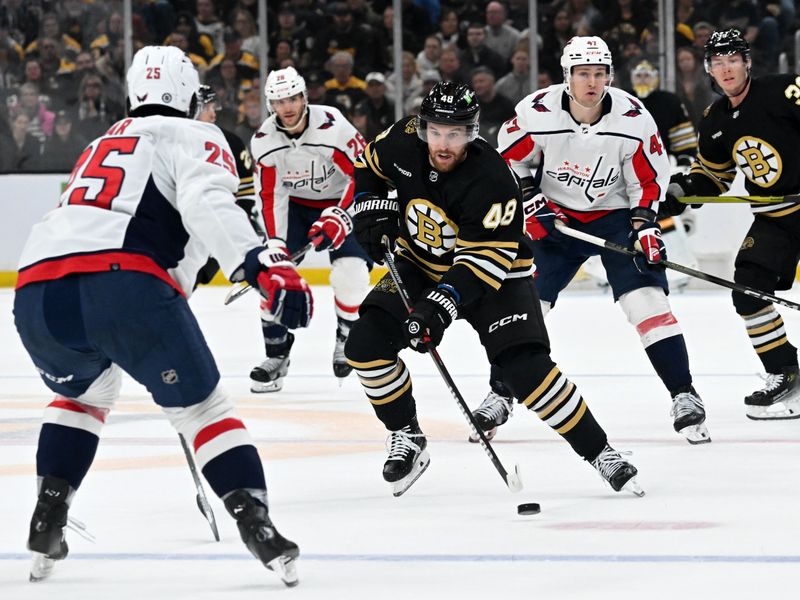 Feb 10, 2024; Boston, Massachusetts, USA; Boston Bruins defenseman Matt Grzelcyk (48) skates against Washington Capitals defenseman Ethan Bear (25) during the first period at the TD Garden. Mandatory Credit: Brian Fluharty-USA TODAY Sports