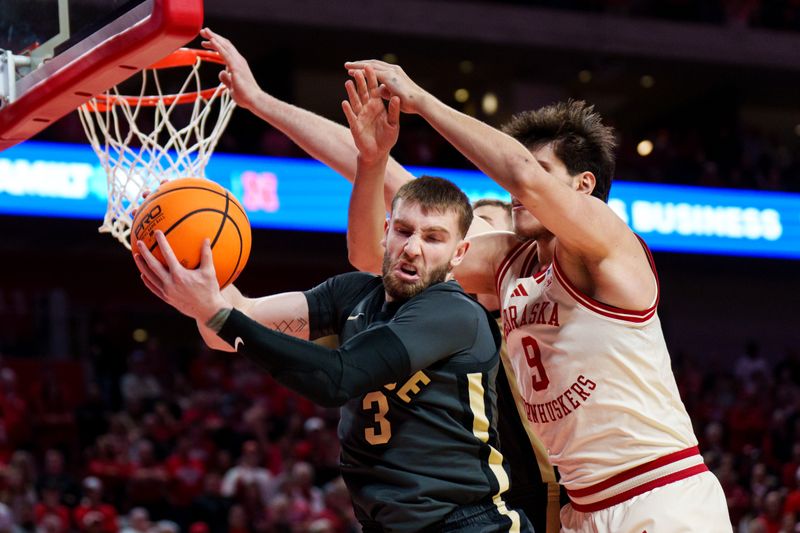 Feb 10, 2026; Lincoln, Nebraska, USA; Purdue Boilermakers guard Braden Smith (3) gets a rebound against Nebraska Cornhuskers forward Berke Buyuktuncel (9) during the first half at Pinnacle Bank Arena. Mandatory Credit: Dylan Widger-Imagn Images