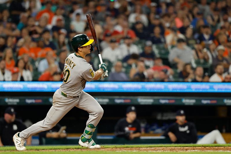 Jun 24, 2025; Detroit, Michigan, USA; Athletics second base Max Muncy (10) hits a single in the sixth inning against the Detroit Tigers at Comerica Park. Mandatory Credit: Rick Osentoski-Imagn Images
