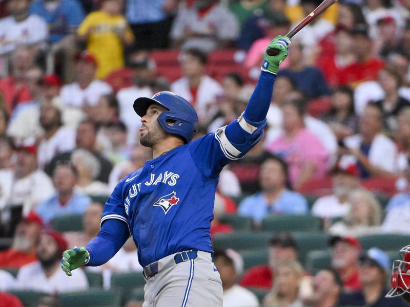 Jun 10, 2025; St. Louis, Missouri, USA;  Toronto Blue Jays designated hitter George Springer (4) hits a one run sacrifice fly against the St. Louis Cardinals during the fifth inning at Busch Stadium. Mandatory Credit: Jeff Curry-Imagn Images