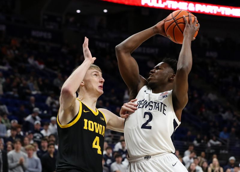 Feb 8, 2024; University Park, Pennsylvania, USA; Penn State Nittany Lions guard D'Marco Dunn (2) looks to shoot the ball as Iowa Hawkeyes guard Josh Dix (4) defends during the first half at Bryce Jordan Center. Mandatory Credit: Matthew O'Haren-USA TODAY Sports