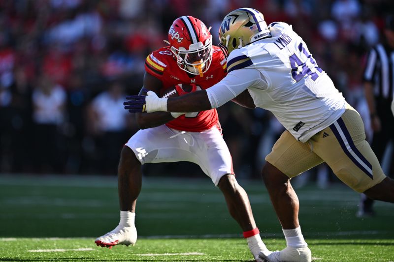 Oct 4, 2025; College Park, Maryland, USA;  Maryland Terrapins running back DeJuan Williams (0) is dropped for a loss by Washington Huskies edge Deshawn Lynch (41) in the first half at SECU Stadium. Mandatory Credit: Jamie Sabau-Imagn Images