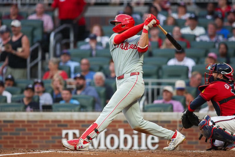 Jul 5, 2024; Atlanta, Georgia, USA; Philadelphia Phillies first baseman Alec Bohm (28) hits a single against the Atlanta Braves in the fourth inning at Truist Park. Mandatory Credit: Brett Davis-USA TODAY Sports