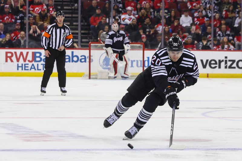 Jan 6, 2024; Newark, New Jersey, USA; New Jersey Devils center Michael McLeod (20) skates with the puck against the Vancouver Canucks during the second period at Prudential Center. Mandatory Credit: Ed Mulholland-USA TODAY Sports